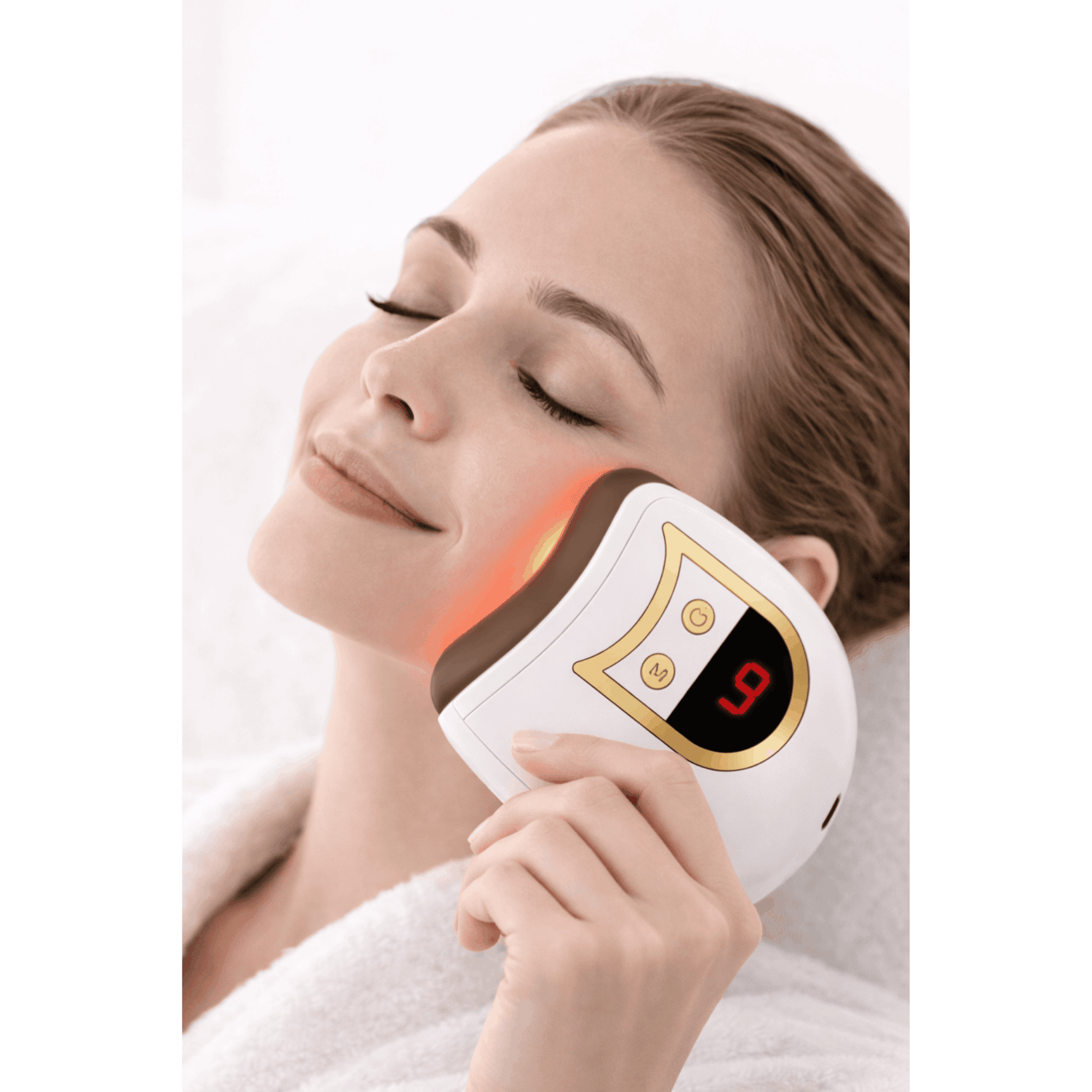 Woman using a facial device on her face with a white background