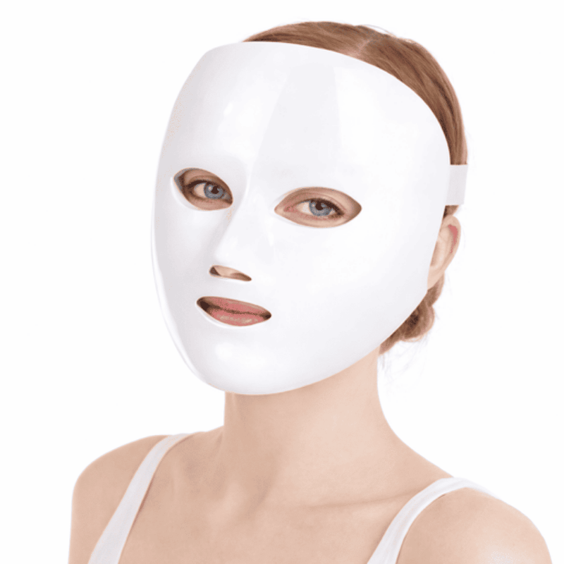 Person wearing a white face mask on a white background