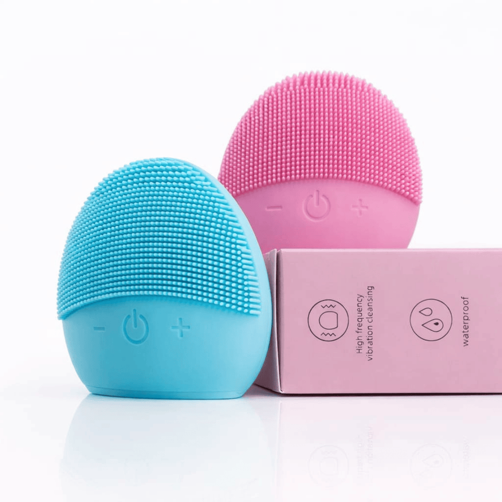 Blue and pink silicone cleaning brushes with a pink box on a white background