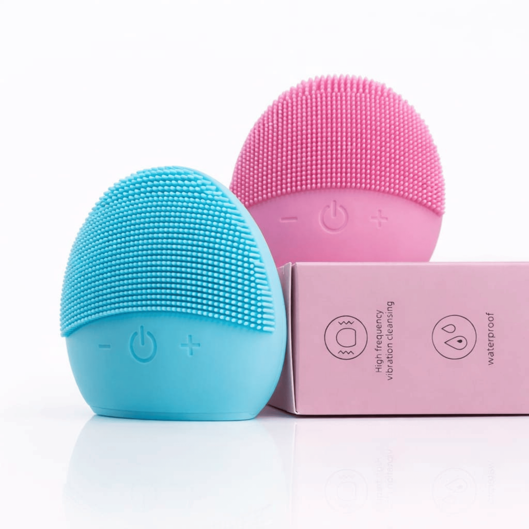 Blue and pink silicone cleaning brushes with a pink box on a white background