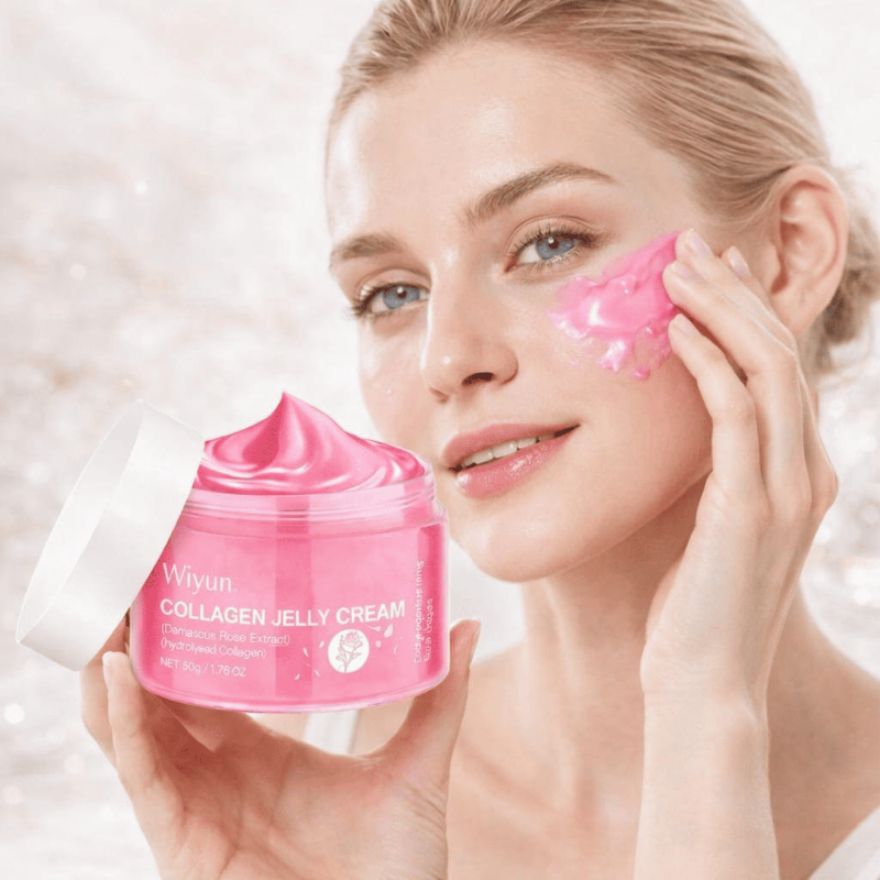 Woman applying pink collagen jelly cream to her face with a jar of the cream in front of her.